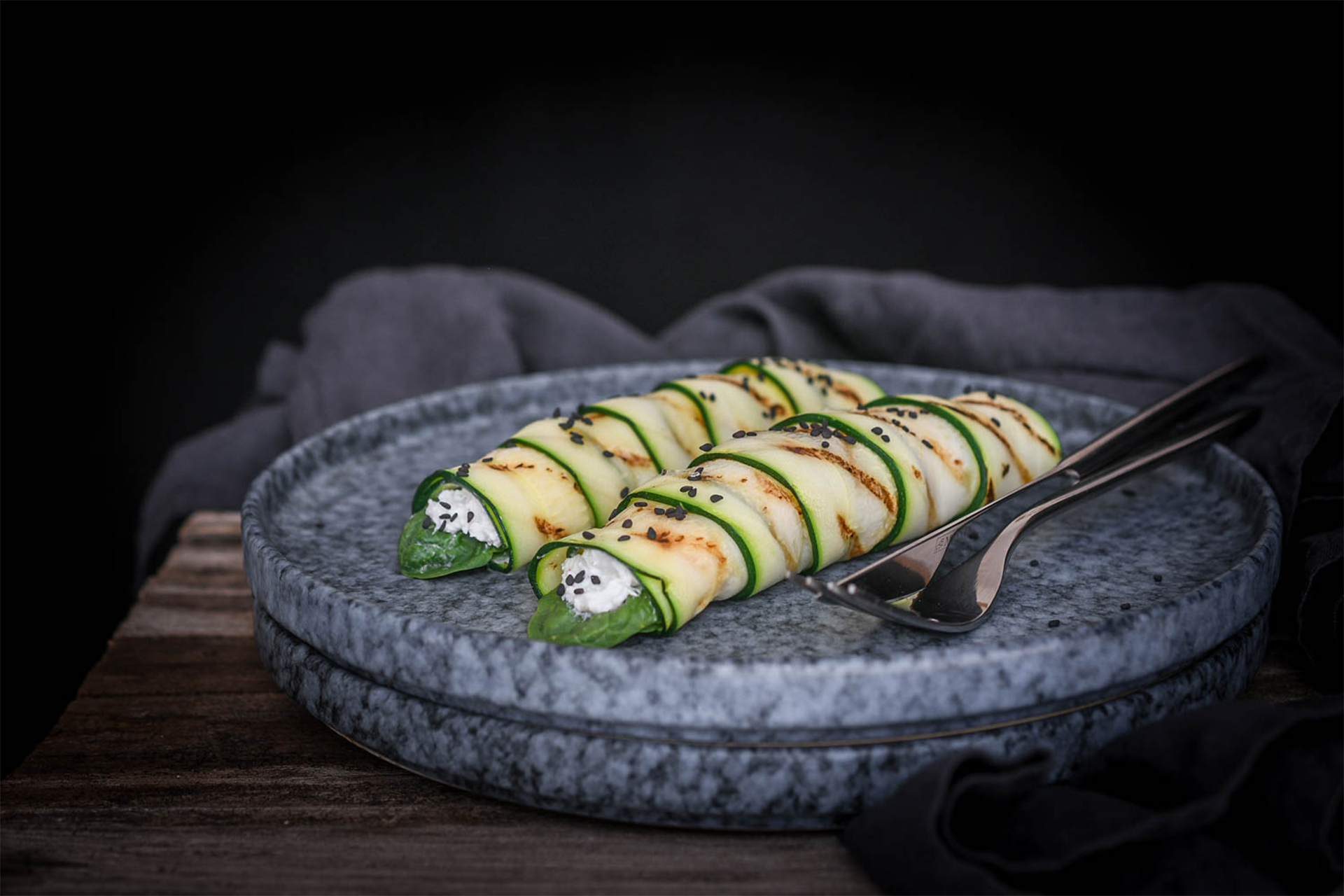 Courgette rolls stuffed with spinach and goat cheese