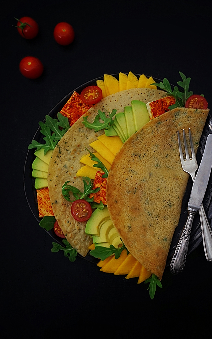 Colourful crepes stuffed with vegetables and cherry tomatoes