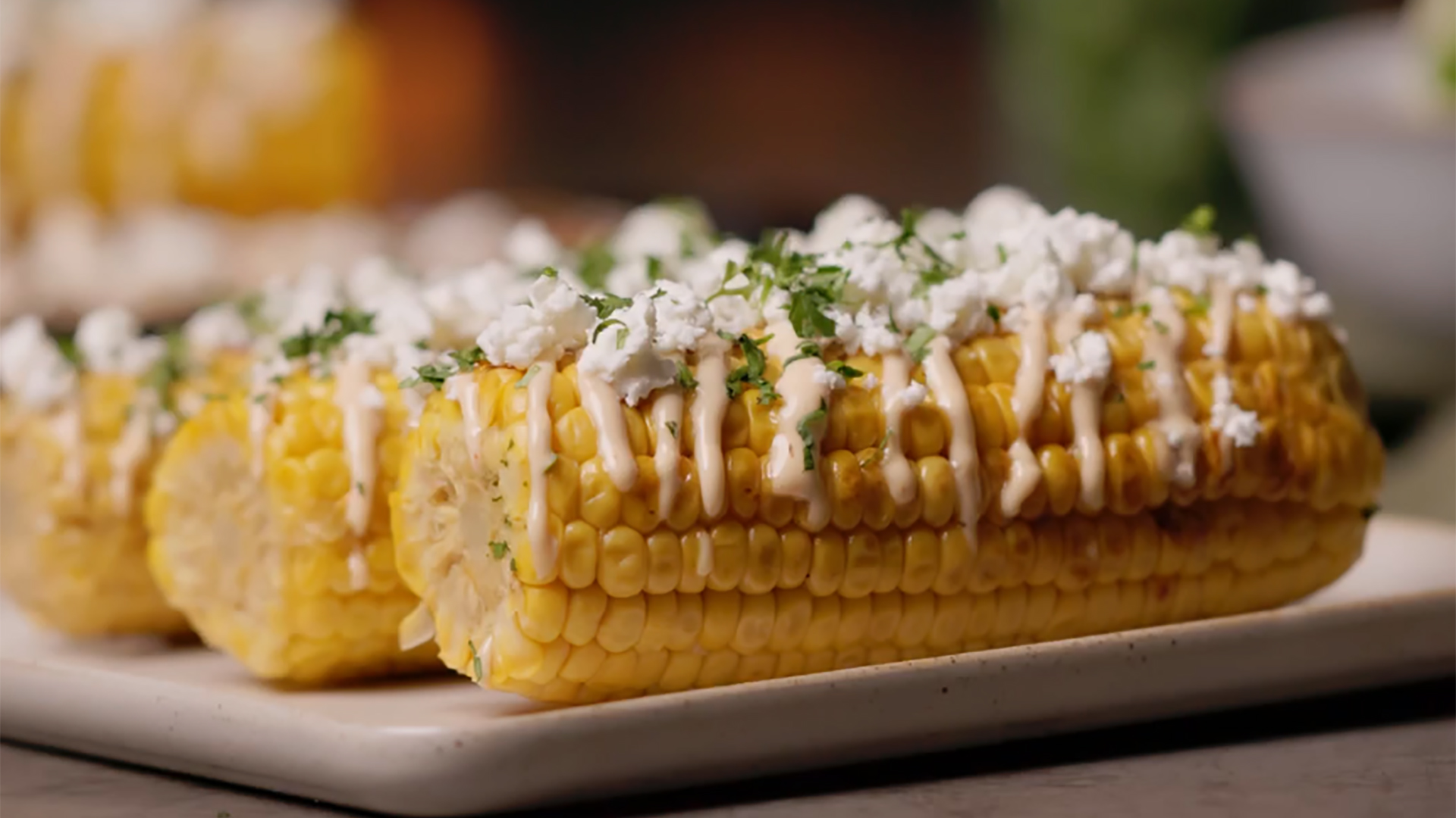 Grilled corn cobs with feta cheese and chipotle