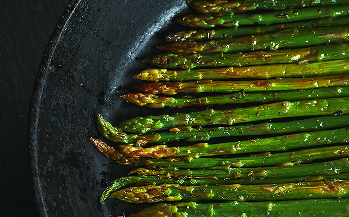 Grilled green asparagus on a grey, elegant dish 