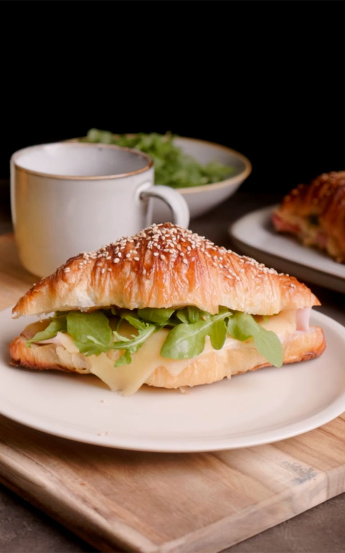 Ham croissant with melted cheese and lettuce