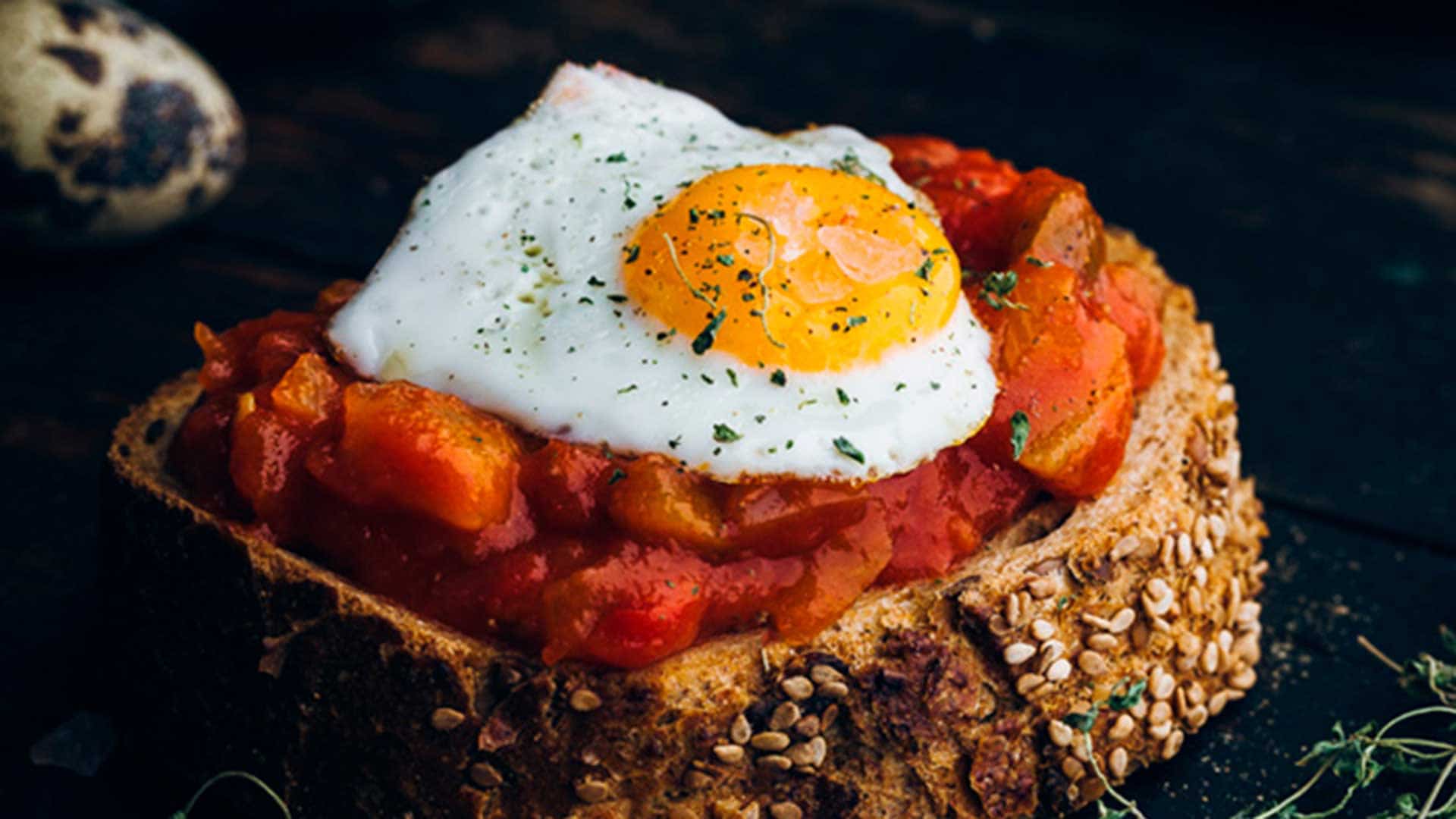 Slice of bread with pisto manchego (Spanish ratatouille) and quail egg from Castilla la Mancha