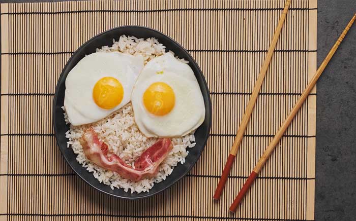 Funny Mulan breakfast with rice, bacon, and chopsticks